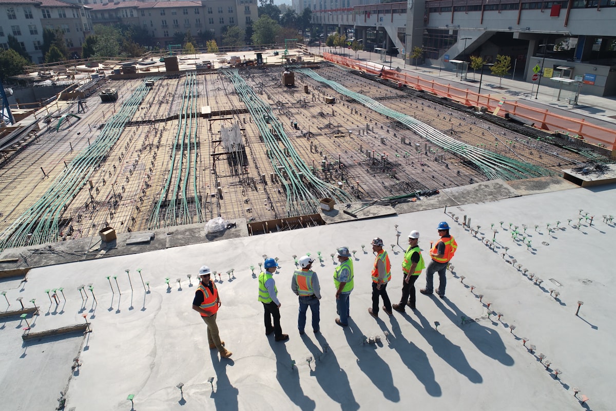 Construction site with engineers reviewing plans